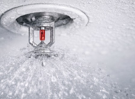 Close-up fire sprinkler head in operation